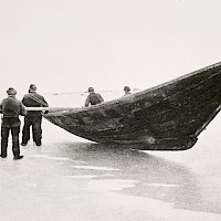 Säljägare från Replot drar fälbåten över isen. Bilden är från början av 1900-talet. Foto: I. K. Inha Museoviraston kuvakokoelmat/Kansatieteen kuvakokoelma KK2969:214
