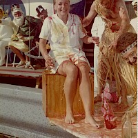 The first time someone crosses the Equator onboard a ship, King Neptune, divine ruler of the seas, baptises the seafarer in a line-crossing ceremony. Lisbeth Sundelin gives an account of her ceremony, which took place on November 23rd, 1972, onboard the passenger ship Kungsholm:  “King Neptune and his party marched up on deck by the swimming-pool, with the orchestra playing in the background. After them came the police officers with all the passengers who were not able to present a valid line-crossing certificate and who therefore were to be baptised. The passengers had got their faces painted and were all dressed up in funny clothes and tied down with ropes. The Captain opened the ceremony and the King held a speech. The Judge then called out the names of all the sinners. They had to crawl up to the King on their knees and admit their guilt. Now the proceedings started, with four men in charge. The passengers got smeared from head to toe in some awful muck and had to kiss an old, rancid fish head. After that, they were shoved into the swimming-pool. Two little devils swimming around in the pool helped them up on deck again.  With all the passengers baptised, I drew a sigh of relief, thinking I had been spared the humiliation. No such luck, though! With the help of two police officers, the Captain pulled me out in front of everyone. I was pushed down onto a stool and then I got smeared with that awful muck and had to kiss that old fish head. When I least suspected it, I got thrown into the swimming-pool, dressed in my uniform and all. The cheers and the joy on deck – you wouldn’t believe it!  Then they got hold of the ship’s doctor. Imagine the sight, when a 130 kg bloke gets thrown into the swimming-pool!  To mark the end of the ceremony we all had christening drinks and I then got my beautiful line-crossing certificate.”  Lisbeth Sundelin’s private archive